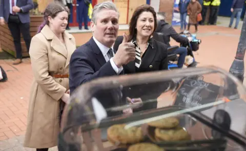 PA Media Labour Party leader Sir Keir Starmer talking to a person at a coffee stand during a campaign visit to Barrow-in-Furness, Cumbria