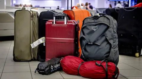 Bags, suitcases and backpacks on the floor of an airport 
