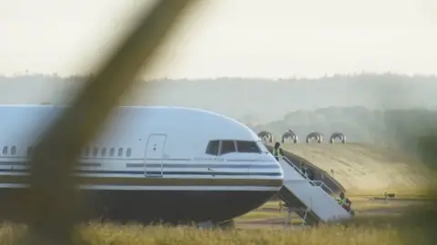 The first asylum seeker flight to Rwanda sitting on a runway