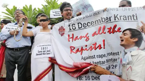 Getty Images Protesters hold posters and placards demanding the death sentence for the convicts in the Delhi gang rape case on September 13, 2013 in New Delhi, India.