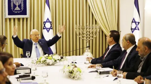 EPA Reuven Rivlin with members of the Joint List alliance at a long table