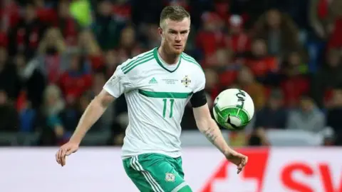 Getty Chris Brunt of Northern Ireland in a white and green Northern Ireland football kit during the FIFA 2018 World Cup Qualifier Play-Off: Second Leg between Switzerland and Northern Ireland at St. Jakob-Park stadium.
