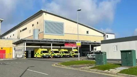 Outside the entrance to Royal Blackburn Hospital's accident and emergency department. Four ambulances are parked outside