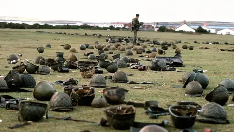 PA Media Steel helmets abandoned by Argentine armed forces who surrendered at Goose Green to British Falklands Task Force troops.