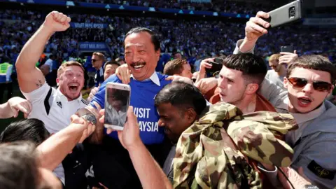 Reuters Cardiff City owner Vincent Tan joins the celebrations
