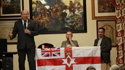 Pacemaker Jim Allister, Jamie Bryson and addressing opponents of the Safeguarding the Union deal in Moygashal