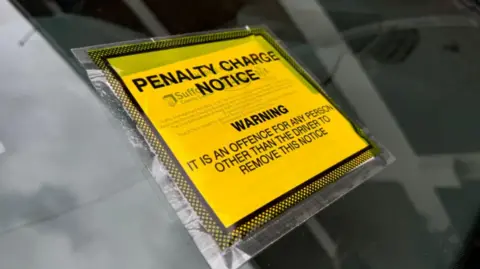 George King/BBC A yellow and black penalty charge notice on a car windscreen