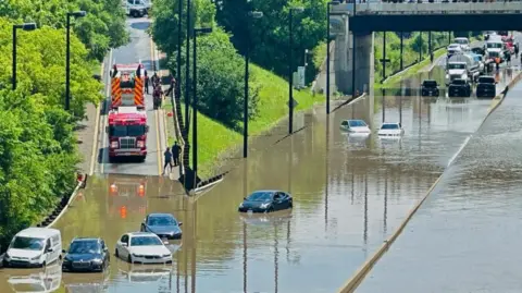 Reuters A cyclist views a flooded section of the Don Valley Parkway after heavy rains hit Toronto, Ontario, Canada July 16, 2024.