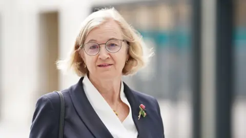 Amanda Spielman pictured outside the BBC in London before an interview in 2023. She is looking at the camera wearing a navy blazer over a white blouse.