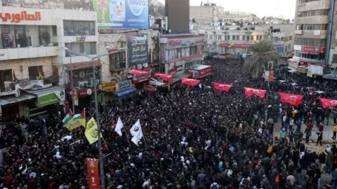 EPA Mourners carry the bodies of Palestinians killed during an Israeli raid in Nablus, in the occupied West Bank, on 22 February 2023