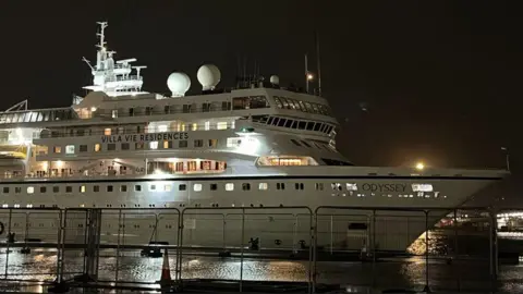 bbc A large white ship in dark waters