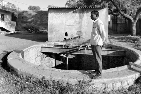 Sudharak Olwe Namdev Kamble, Rajashree’s father, standing over the well where his daughter slipped and fell.