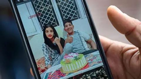 Maria Khan The portrait of twins, Zain Ali and Urwa Fatima, who are seen with a cake in front of them
