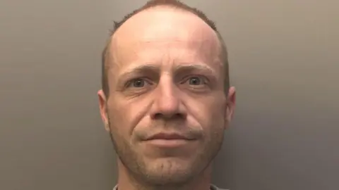 Merseyside Police Rory Allington-Mott is balding with short brown hair and facial hair