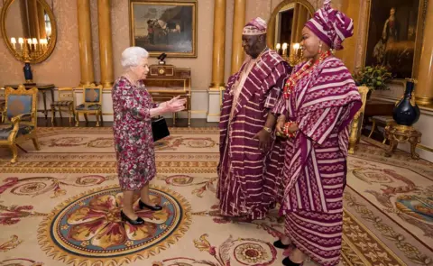 AFP Queen Elizabeth II of the UK greets Nigeria's ambassador to the UK George Adesola Oguntade and his wife during a Modupe Oguntade during a private audience at Buckingham Palace in central London, UK - Wednesday 6 December 2017