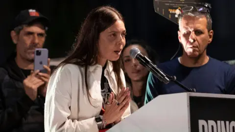 Getty Images Moran Stella Yanai speaking at a rally demanding the return of hostages