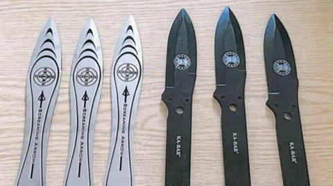 Six knives: three silver throwing knives and three small black knives