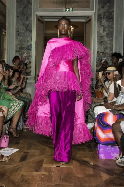 Africa Fashion at the V&A Model wearing a shimmering pink outfit