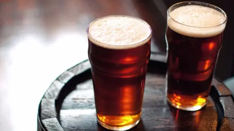 Getty Images Two pints of beer on a barrel