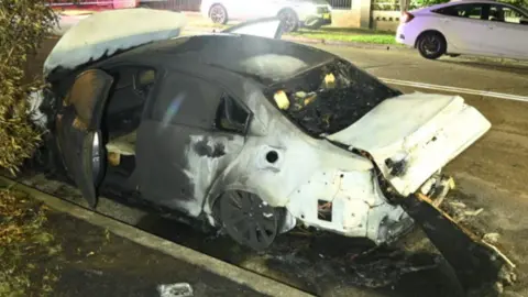 NSW Police A burnt out car picture at night on a road