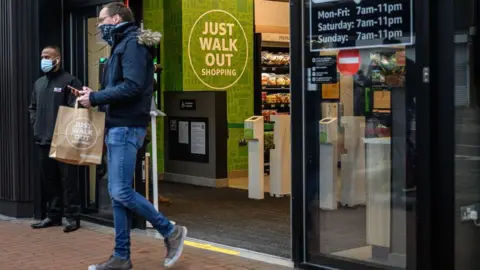 Getty Images A shopper walking out of an Amazon Fresh store in London in 2021