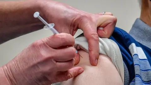 PA Media A patient receives the Astra Zeneca/Oxford University Covid-19 vaccine in Merthyr Tydfil