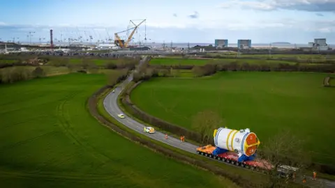 EDF The final journey was a five-hour trip for four miles by a transporter to its permanent home on the construction site.