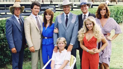 Getty Images Cast assembled on the property of the Southfork ranch, on the outskirts of Dallas, Texas, 1979. From left, American actors Steve Kanaly (as Ray Krebbs), Patrick Duffy (as Bobby Ewing), Victoria Principal (as Pamels Barnes Ewing), (sitting), Barbara Bel Geddes (as Eleanor Southworth 'Miss Ellie' Ewing), Jim Davis (as John Ross 'Jock' Ewing), Larry Hagman (as John Ross 'J.R.' Ewing, Jr.), Charlene Tilton (as Lucy Ewing) (in red), and Linda Gray (as Sue Ellen Ewing)