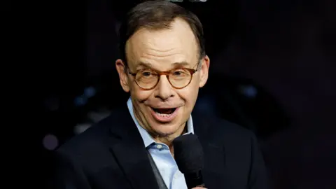 Reuters Rick Moranis speaks into a microphone at CinemaCon