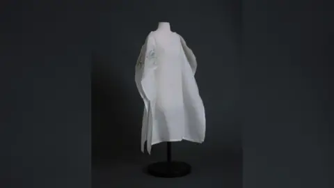 Salisbury Museum A miniature mannequin wearing a white cape