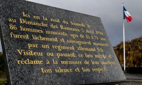 Getty Images A commemorative plaque is pictured on November 13, 2017 in Villeneuve-d'Ascq, northern France, reminding of the April 2, 1944 WWII massacre of 86 civilians
