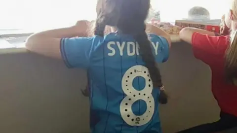 Family handout Sydney wearing the shirt given to her by her father