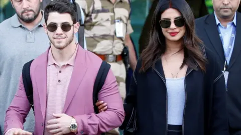 Reuters Ms Chopra (R) and Mr Jonas arrive in Udaipur