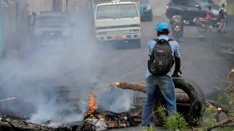 Reuters Man at a road block in Port-au-Prince, 14 July 2022