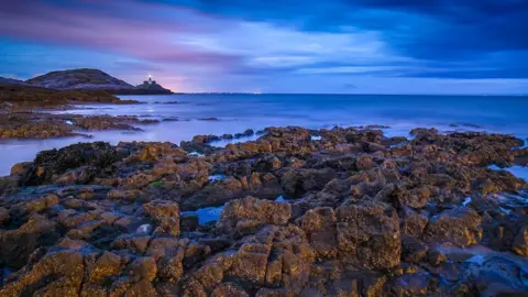 Jonathan Demery A moody sky overlooking Mumbles lighthouse and Bracelet Bay in Swansea taken by Jonathan Demery