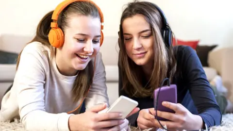 Getty Images Girls on their phones