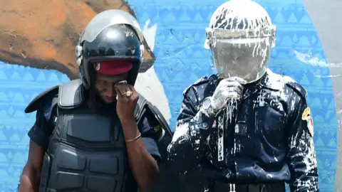 Anti-riot police officers, one covered in white paint, in Dakar, Senegal - Friday 25 June 2021