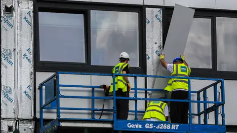 cladding being removed from Whitebeam Court, in Pendleton, Greater Manchester, 2017