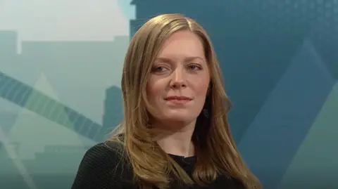 Labour MP Sarah Edwards, a woman with long light brown hair, wearing a black top. She is in a television studio. 