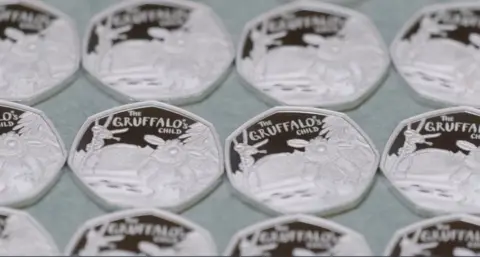 Royal Mint The Gruffalo's Child coin in the shape of a 50 pence piece