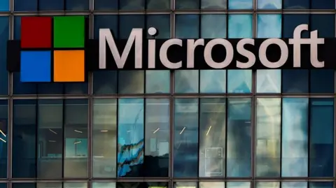 The Microsoft logo is lit up on a glass building in Paris