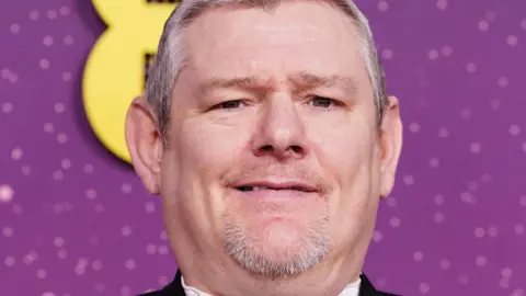 PA Media John Davidson with a tuxedo