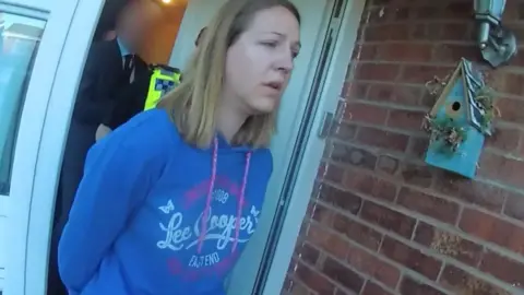 Cheshire Constabulary Lucy Letby is arrested wearing a blue hoodie