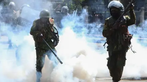 EPA Armed members of the Kenyan security forces fire teargas at demonstrators during a protest near the Parliament against tax hikes, in Nairobi, Kenya, 25 June 2024