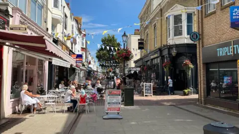 A picture of people walking up Warwick Street in Worthing.
