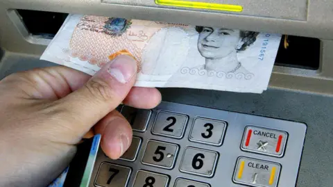 A person using a cash machine