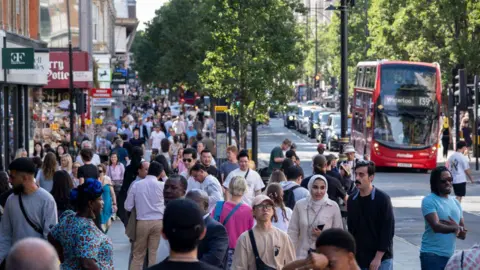 Getty Images People walking down a crowded street