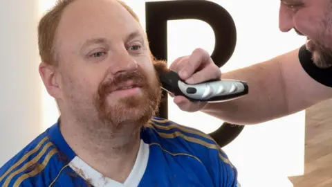 Eli Drury is pictured mid shave