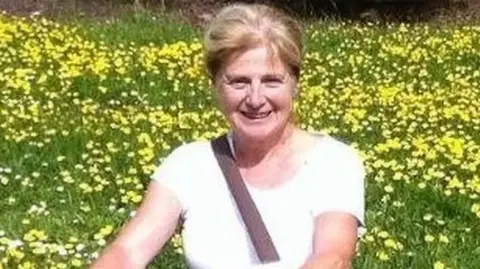 Wiltshire Police Danielle Carr-Gomm in a field of yellow flowers