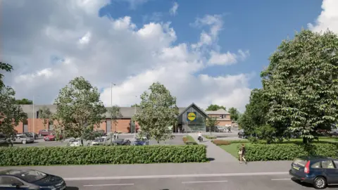 Lidl GB The long two-storey brick building has a grey roof and a yellow and blue sign above the door which reads: Lidl. There is a carpark out front, which is dotted with trees, and a road in the foreground. There are people and cars dotted around the scene.